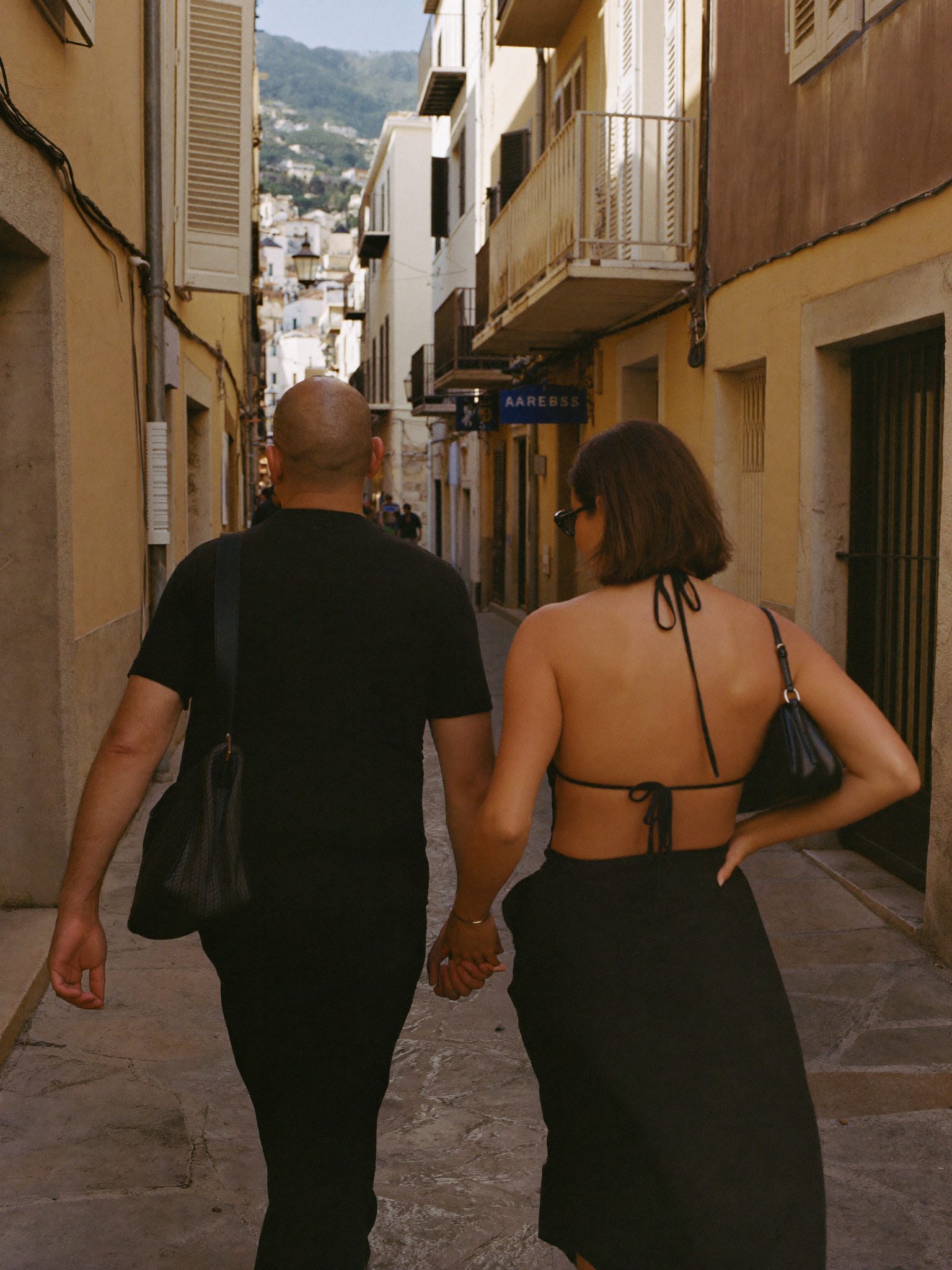 Couple marchant dans une ruelle de village méditerranéen